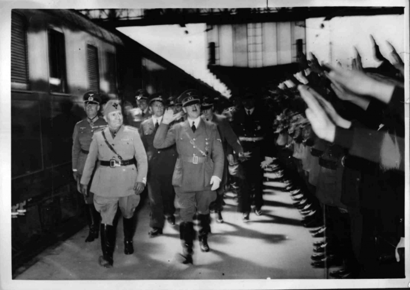 Adolf Hitler and Benito Mussolini greet the crowd in Munich's station